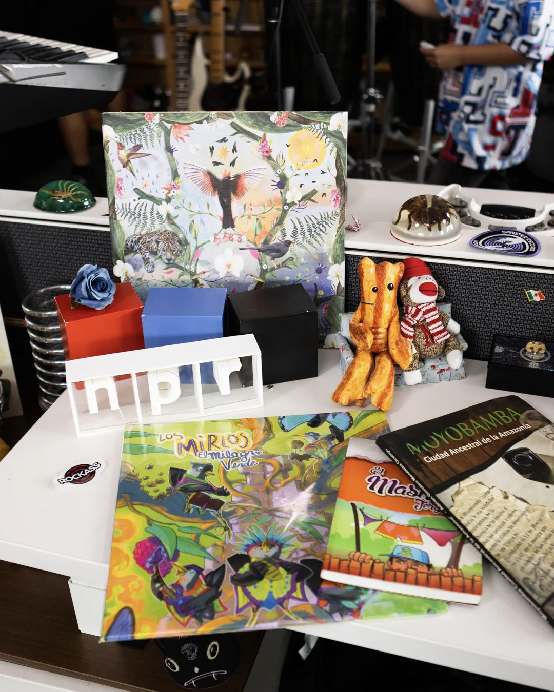 The World Meets Los Mirlos vinyl, books about Moyobamba and the NPR logo on the Tiny Desk